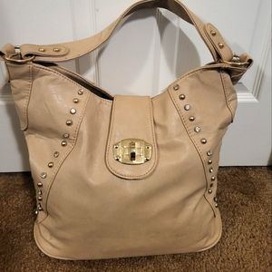 Tan faux leather purse with studded embellishments. Used.